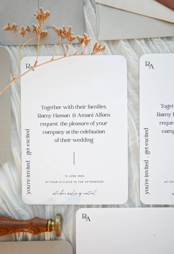 couple reviewing wedding invitation samples and mood board spread on a table wedding stationery