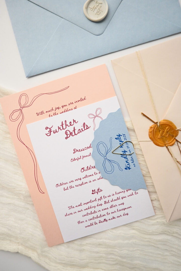 Wedding invitation suite with wax seals, ribbon, and hand-tied finishing details
