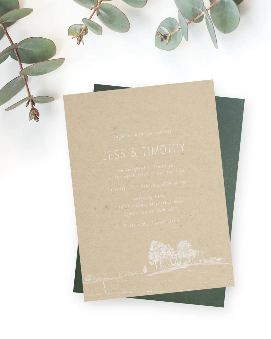 Eco-friendly wedding invitation on natural kraft paper with white ink and eucalyptus styling