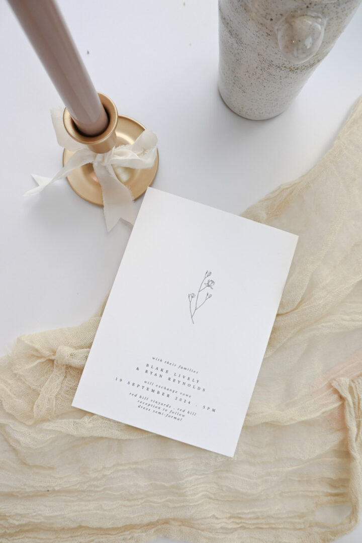 Minimalist botanical wedding invitation with floral detail
