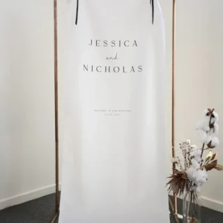 Byron fabric wedding welcome sign hung on a copper stand with dried florals: Paperlust fabric wedding signs