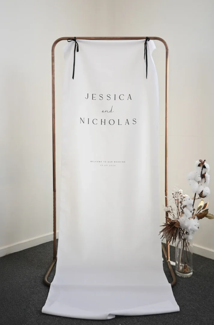 Byron fabric wedding welcome sign hung on a copper stand with dried florals: Paperlust fabric wedding signs