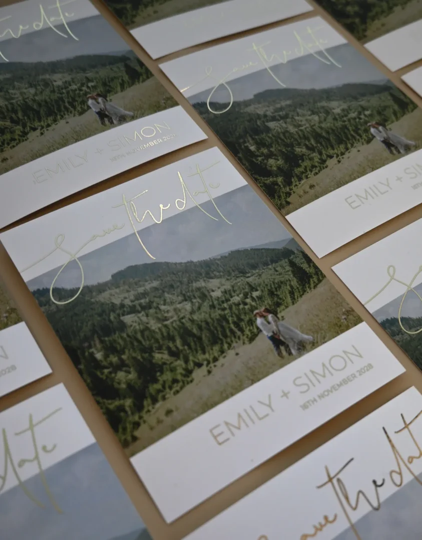 Photo save the date card with gold flat foil script lettering on landscape photo