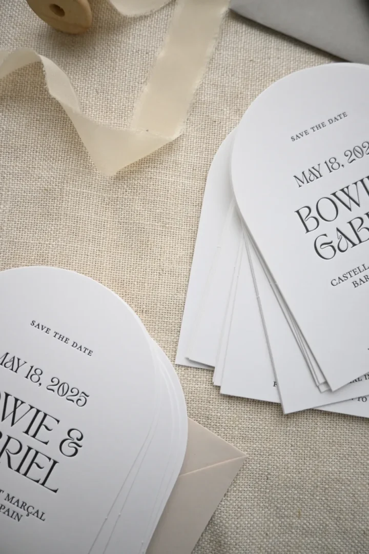 Letterpress save the date cards with debossed black typography on thick white stock