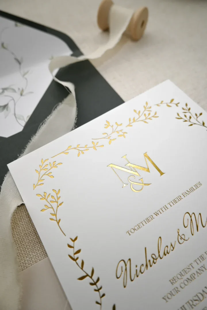 wedding invitation flat lay showing variety of styles - botanical, minimalist, bold graphic side by side wedding stationery