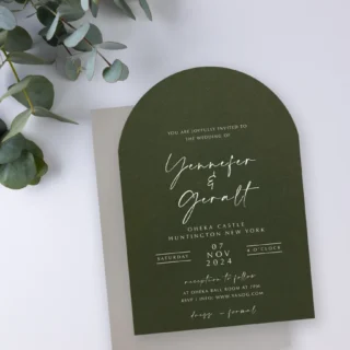 Forest green arch-shaped wedding invitation styled with eucalyptus — elegant Paperlust wedding invitation design