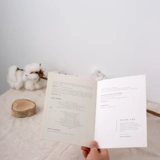 Open wedding ceremony program booklet showing order of service interior pages: Paperlust wedding program booklets