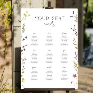 Wedding seating chart display — Your Seat Awaits calligraphy board with guest name assignments