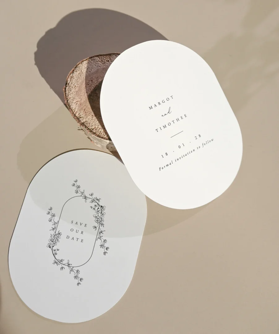 close-up of bride and groom holding hands at ceremony altar, rings visible, emotional expressions, warm natural light wedding stationery