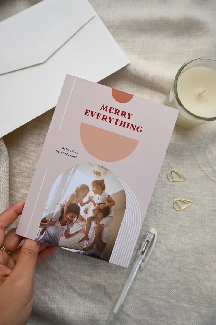 groom holding a folded card at ceremony, reading vows, partner smiling with tears, candid moment captured from slight side angle wedding stationery