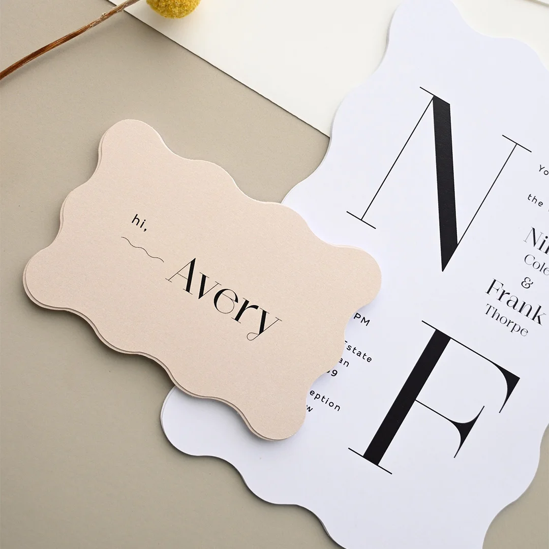 open wedding planning notebook with a handwritten postage budget breakdown, surrounded by invitation card samples, a stamp booklet, and a pen on a white desk wedding stationery