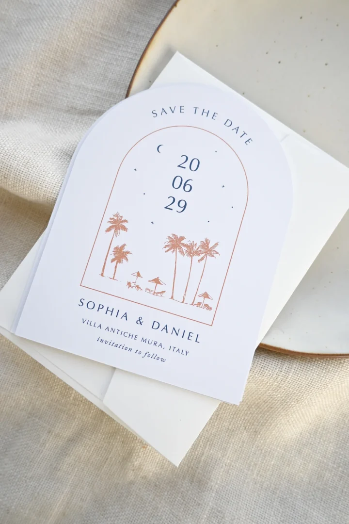 overhead flat-lay of printed save the date cards, envelopes, and a planning calendar spread on a linen surface -- warm natural light, lifestyle wedding stationery wedding stationery