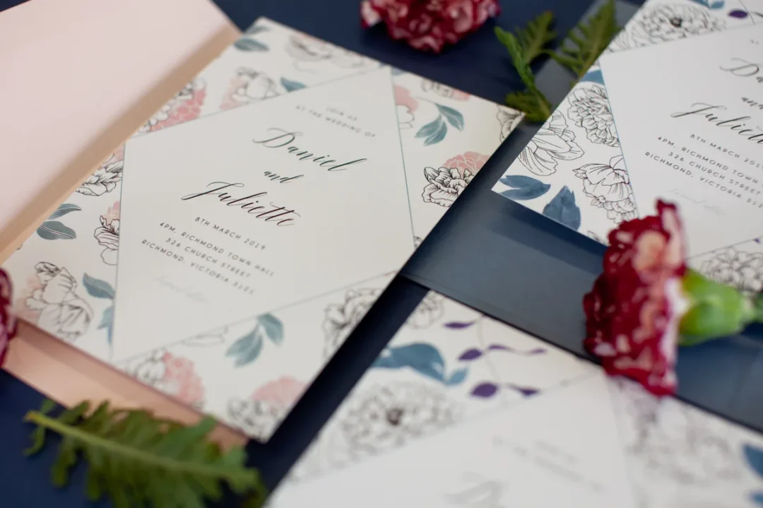Elegant floral wedding invitation with addressed envelope detail