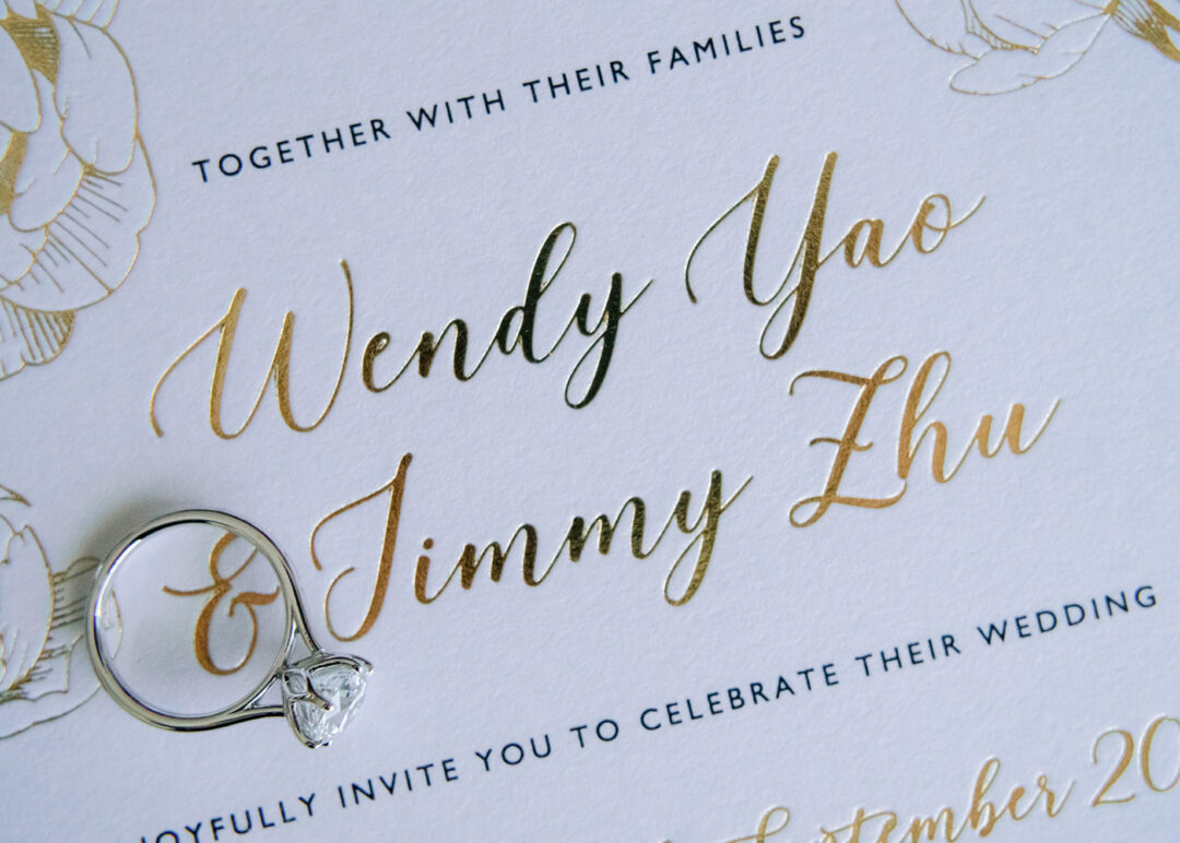Gold foil calligraphy wedding invitation with peony illustration