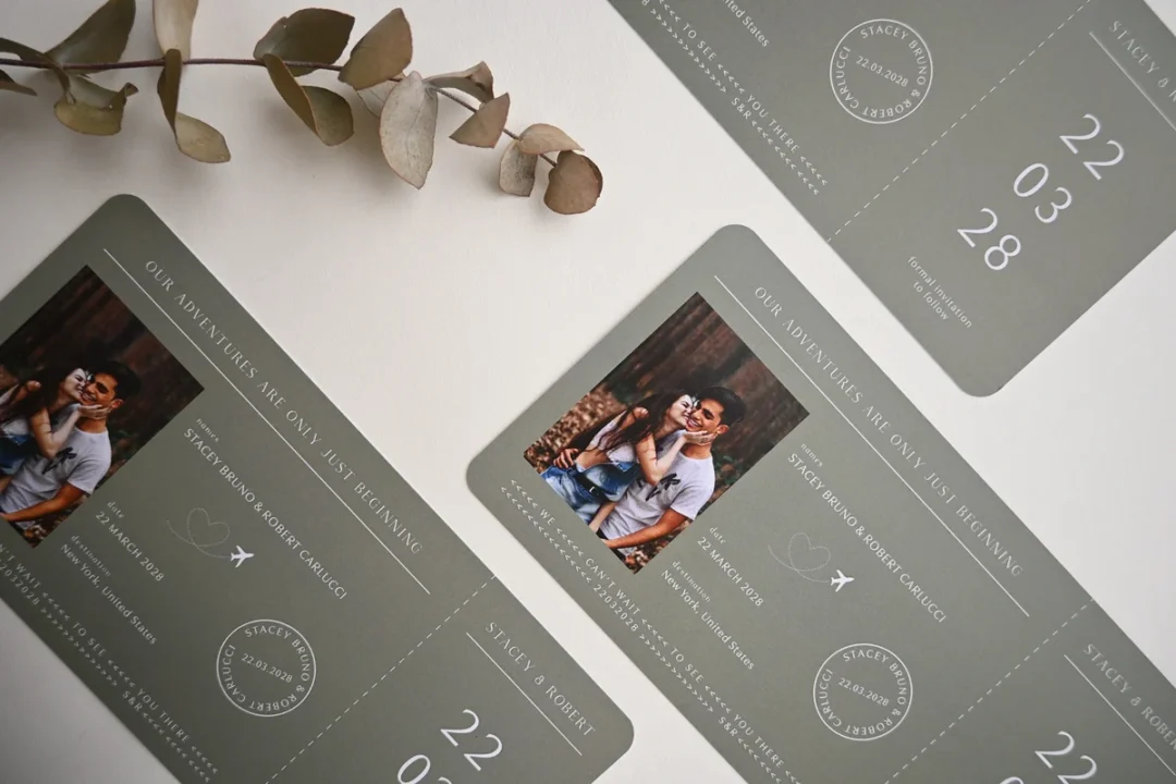travel-themed wedding stationery suite with destination luggage tag, folded boarding pass invite, and passport holder on a globe map surface wedding stationery