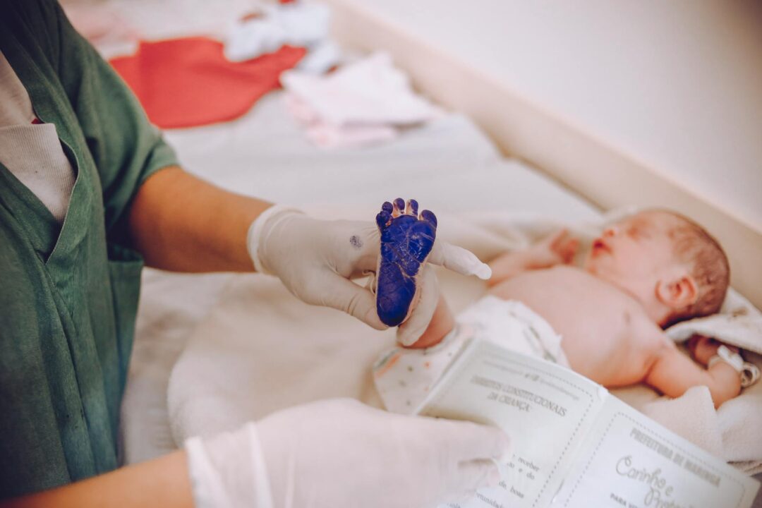 close-up of birth announcement detail showing baby's footprint imprinted on premium cotton stock