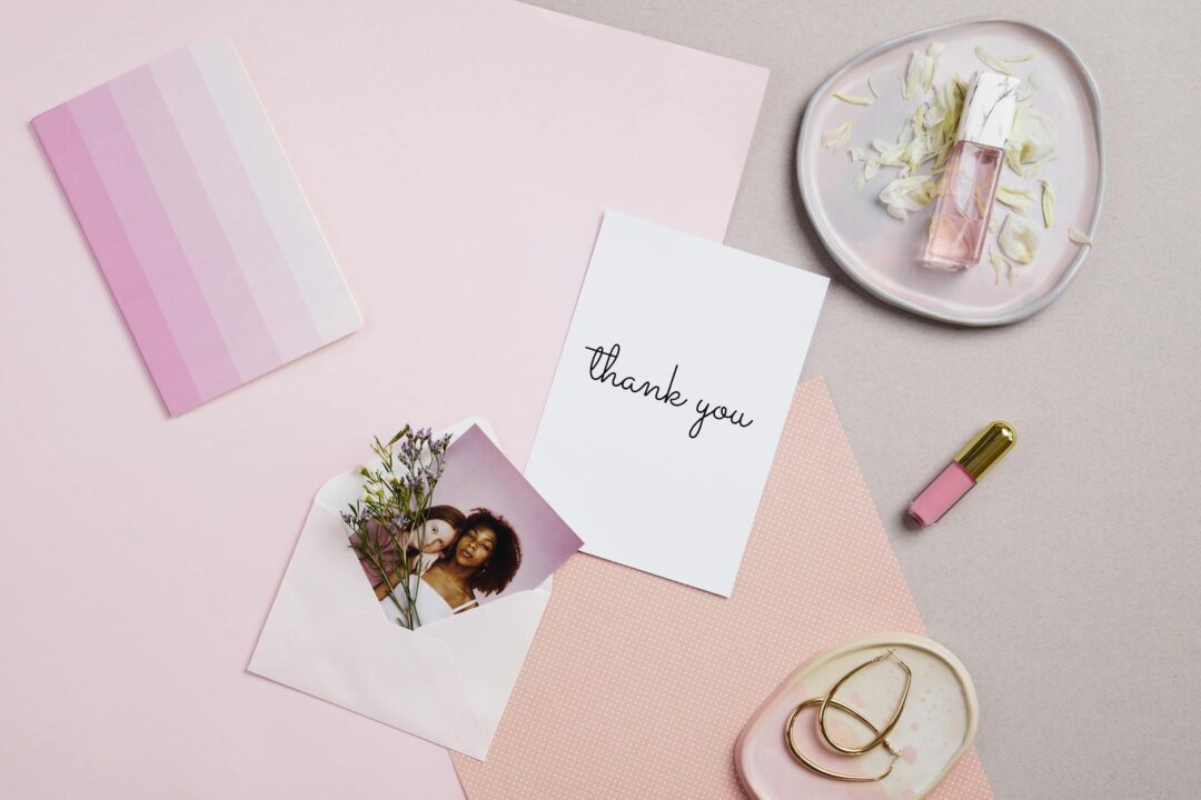 thank you card and birth announcement side by side on a desk, showing the natural follow-up flow