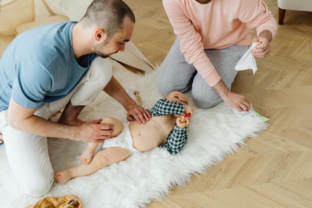 family photo birth announcement of two parents with newborn, capturing a same-sex parent family for inclusive visual representation