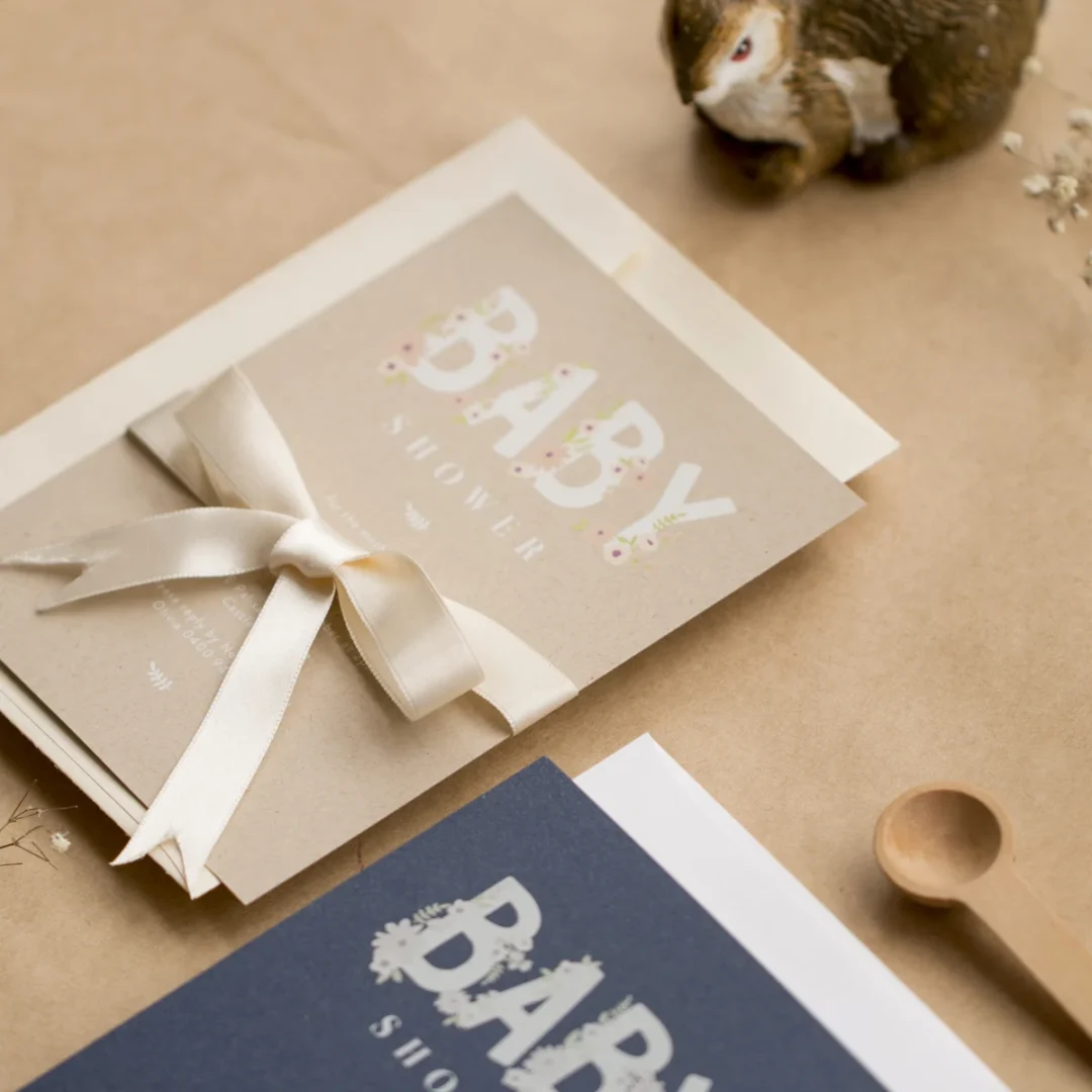 Paperlust baby shower stationery product shot with ribbon and neutral styling