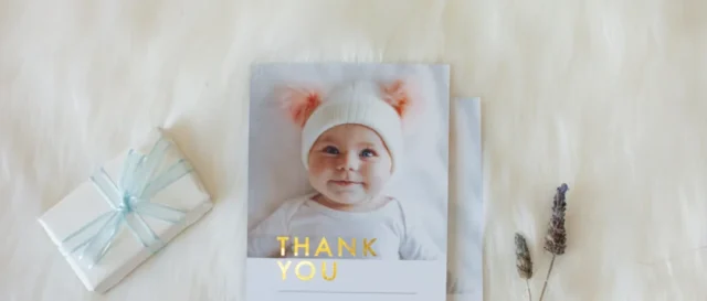 Paperlust baby photo card with gold foil thank you text and gift styling