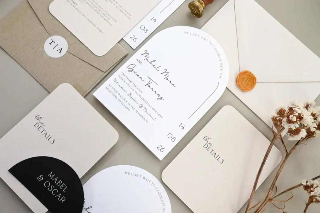 Styled bridal shower invitation flatlay on neutral kraft paper with floral accents