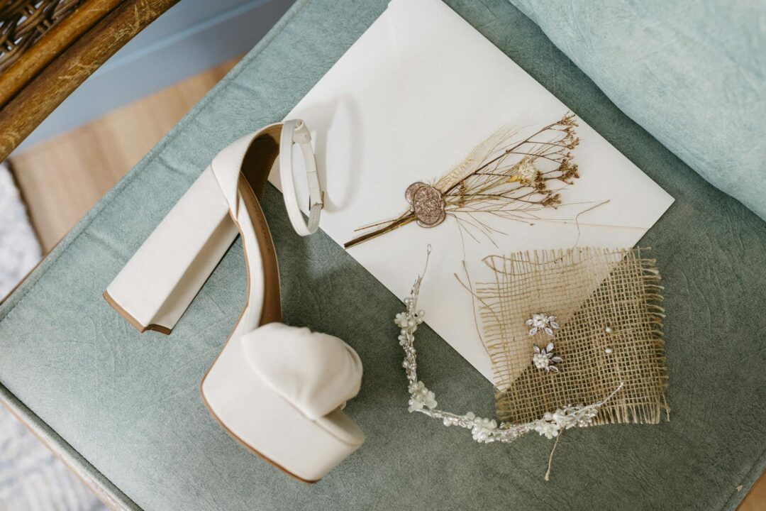 Flat lay of Paperlust bridal shower invitations in soft blush and cream tones, printed on premium matte stock with gold calligraphy script,