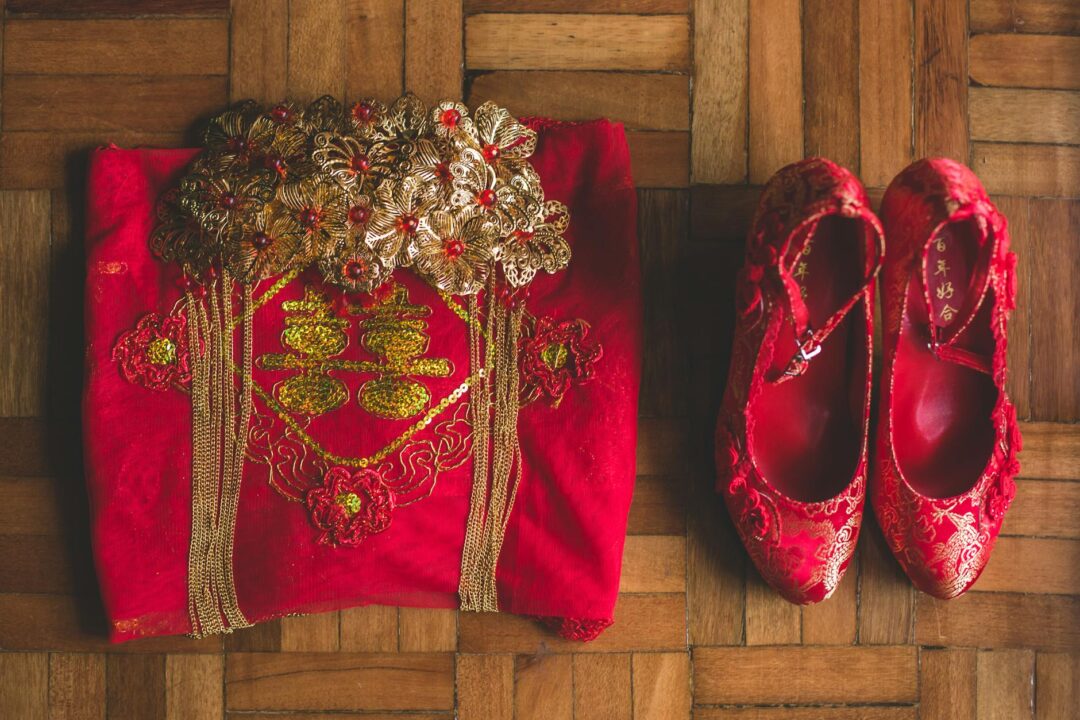 Gold dragon and phoenix embroidery on red qun kwa fabric, traditional Chinese bridal garment