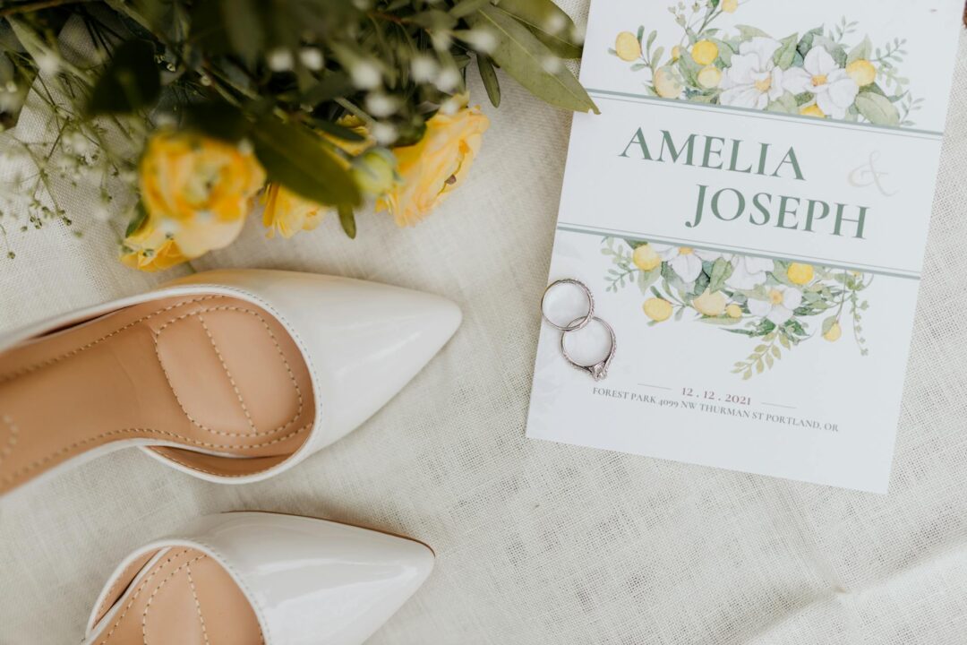 Paperlust engagement party invitation suite flatlay, blush watercolor design with gold lettering, styled with botanical greenery on marble s
