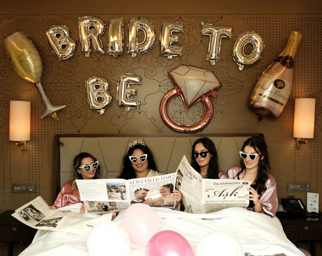weekend hens party activities, women at a dinner table laughing during a group game, fairy lights and floral centrepieces in a holiday house