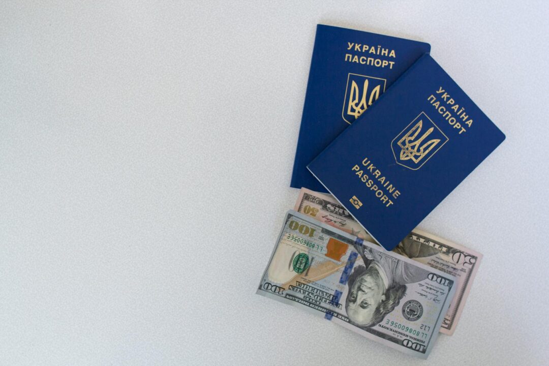 couple reviewing travel documents and passports spread on a table alongside a world map and coffee