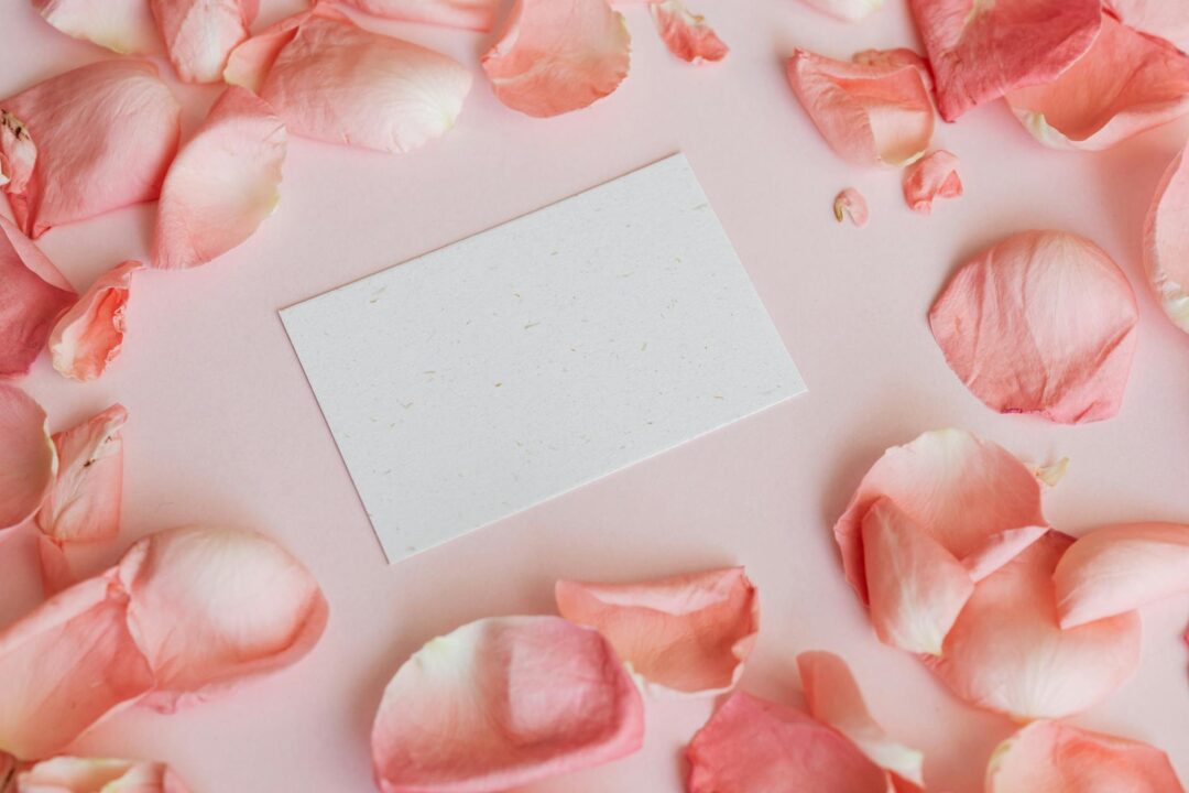 Flat-lay overhead shot of a complete Paperlust wedding invitation suite spread on a marble surface showing the invitation card, RSVP card, d