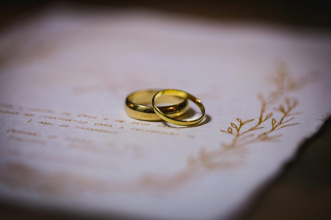 Paperlust wedding invitation flatlay showing a complete assembled suite with vellum wrap secured by a wax seal on a linen-textured surface,