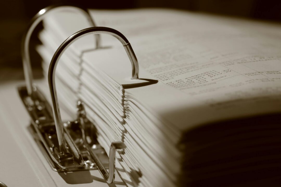 Open leather binder with ceremony script on lectern