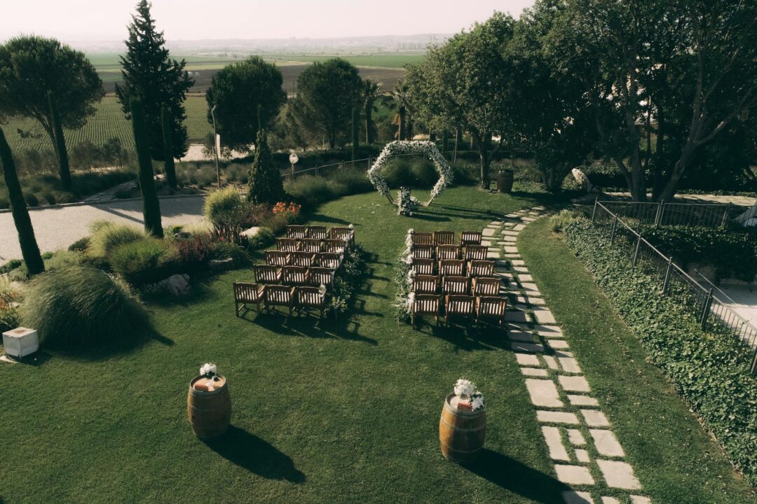 Wooden ceremony backdrop with greenery and couple monogram