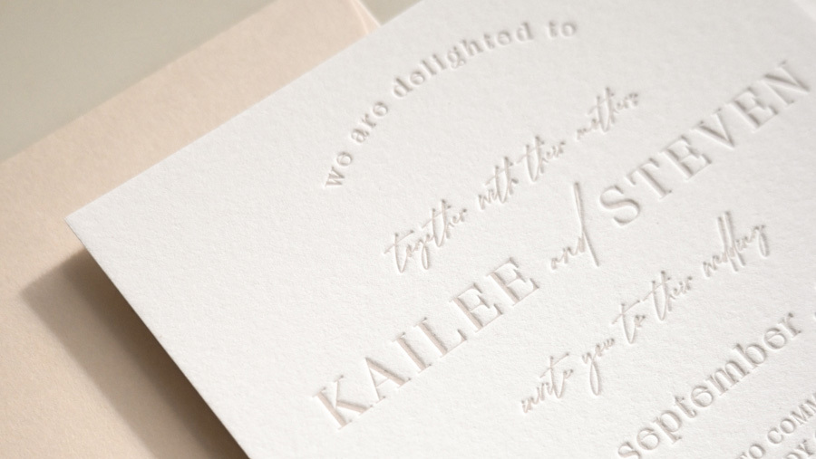 Letterpress wedding invitation suite with botanical accents on cotton paper