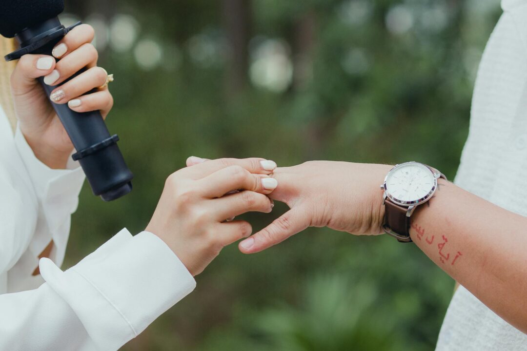 Couple exchanging personal vows at outdoor ceremony