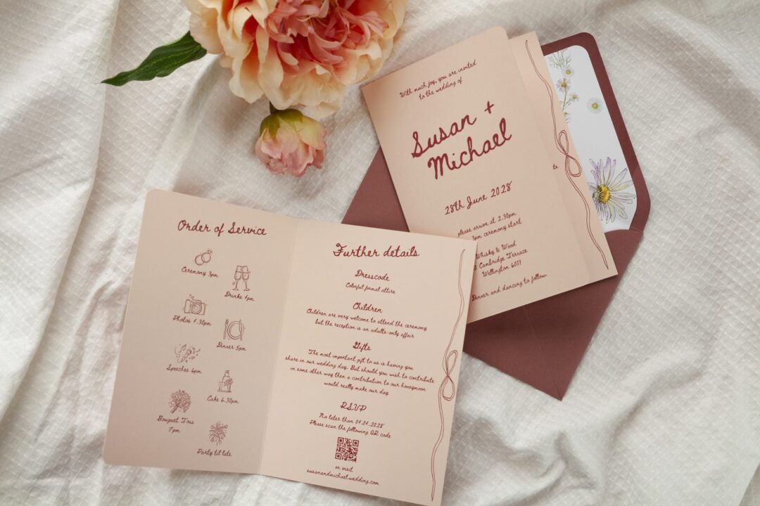 Paperlust Francesca bifold wedding invitation on dusty rose cardstock with cream illustrated detailing