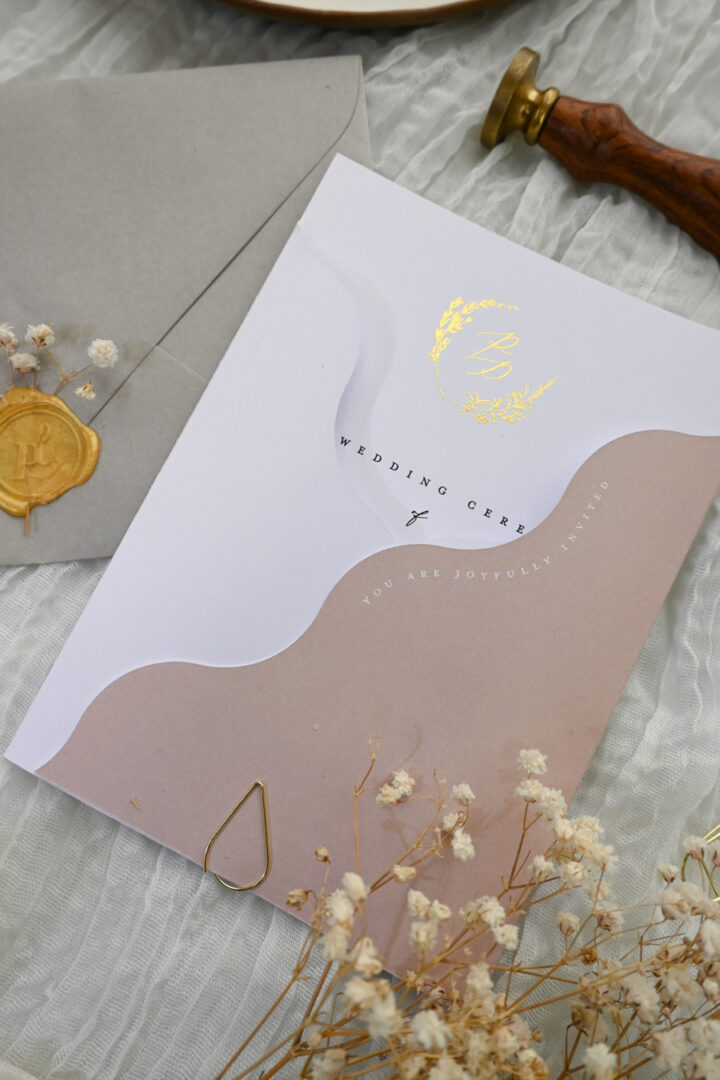 Paperlust Leaf Crest wedding invitation suite, white and dusty mauve wave card with gold foil monogram, dusty rose ombre, gold wax seal, dried baby's breath on cheesecloth