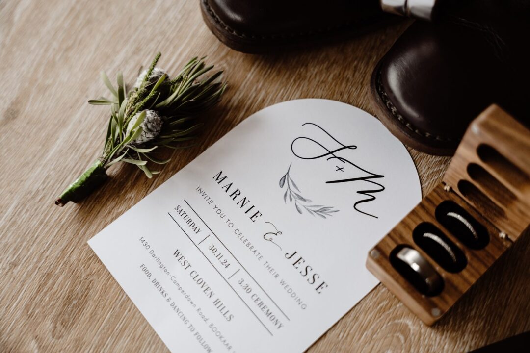 Real wedding photo of Paperlust Milieu arch die-cut wedding invitation in warm cream stock with serif typography