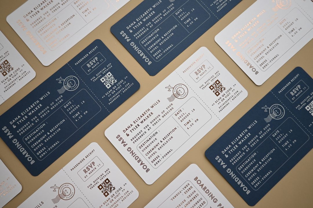 Paperlust rsvp, Beautifully styled flat lay of boarding pass-themed wedding invitations in navy and white with gold foil accents. Destination wedding suite for Dubrovnik with clean