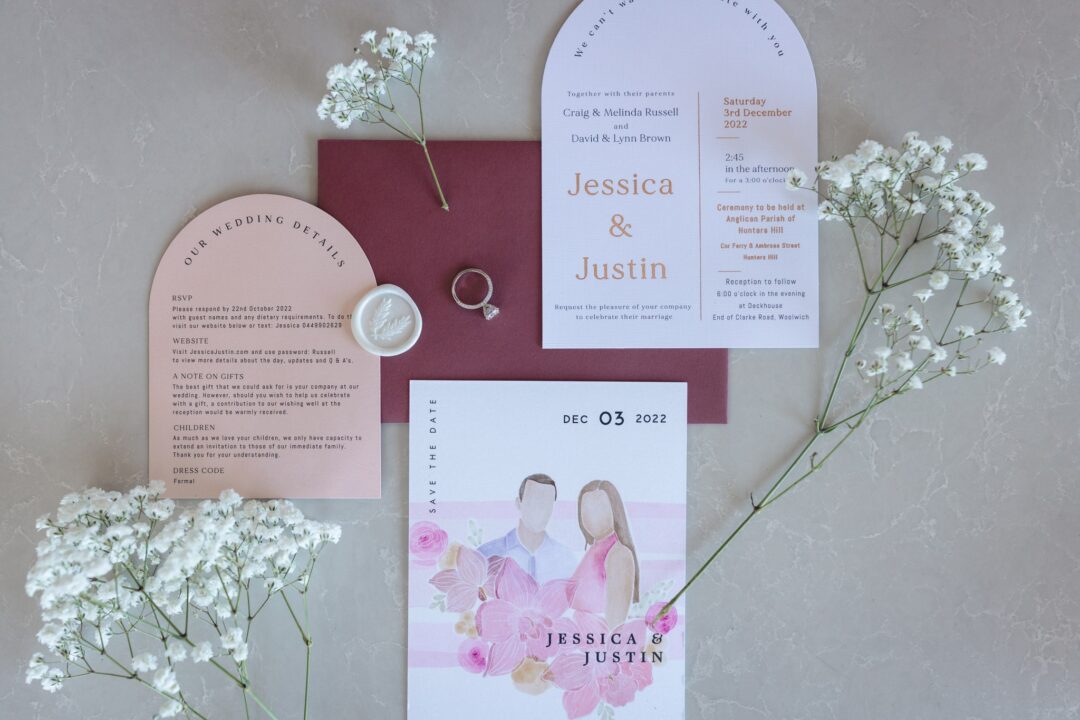 Paperlust wedding invitation suite with wax seal -- arch invitations in blush and white with rose gold typography, burgundy envelope with custom monogram wax seal, baby breath floral styling