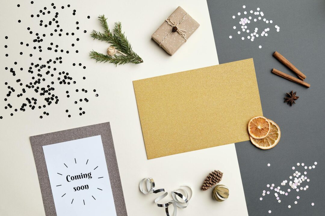 Flatlay of Paperlust birth announcement cards in a mix of styles, botanical, minimalist, and flat foil, arranged with a small swaddle blanke