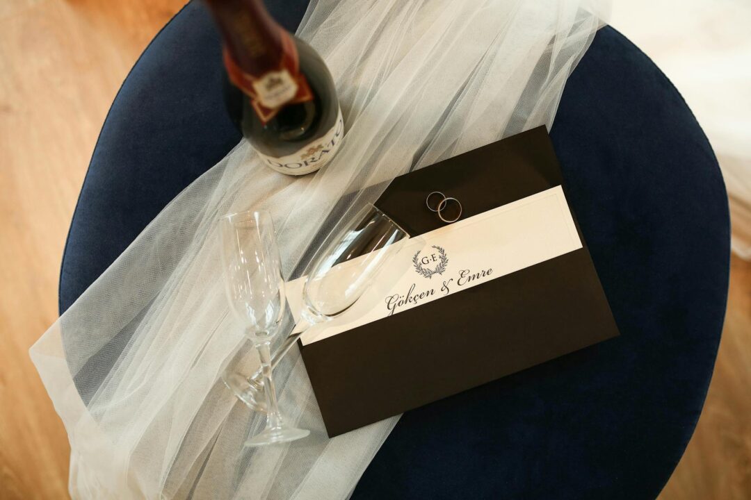 Paperlust pocket wedding invitation suite partially assembled, showing layered insert cards being placed inside a cotton-stock pocket fold,