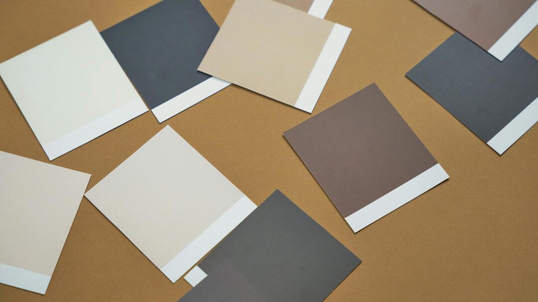 Paperlust wedding invitation paper stock samples laid flat, showing matte digital stock, cotton letterpress stock, and linen-textured stock