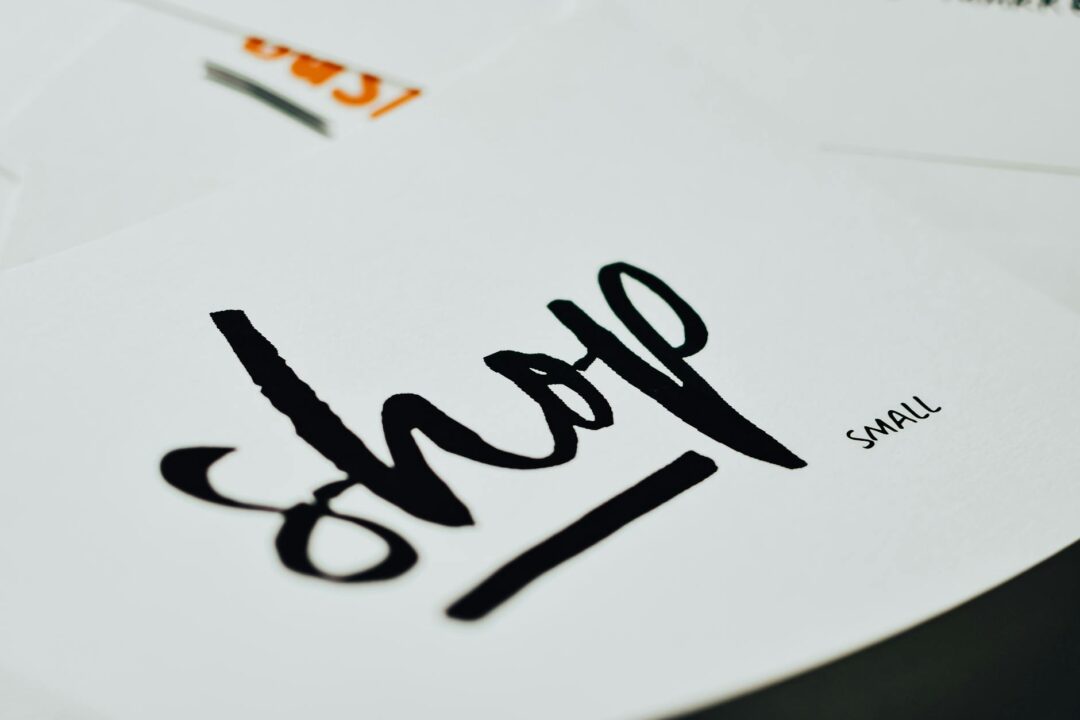 Paperlust invitation suite detail card close-up showing elegant typography and coordinating paper stock, held in hand, no personal informati