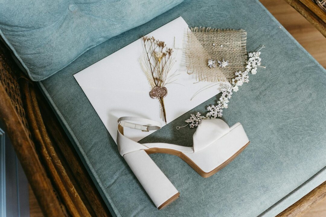 Paperlust elegant minimalist wedding invitation styled with muted pink tulip on linen fabric - beautiful soft lighting and refined compositi