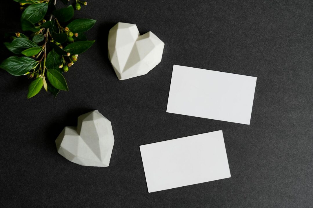 Paperlust arch-shaped invitation suite flatlay with RSVP cards, dried florals and satin ribbon, soft neutral palette. Use for venue section
