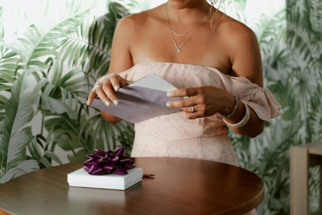 Paperlust birthday invitation suite styled flatlay, milestone 18th party, warm gold tones on white marble surface, overhead shot showing inv