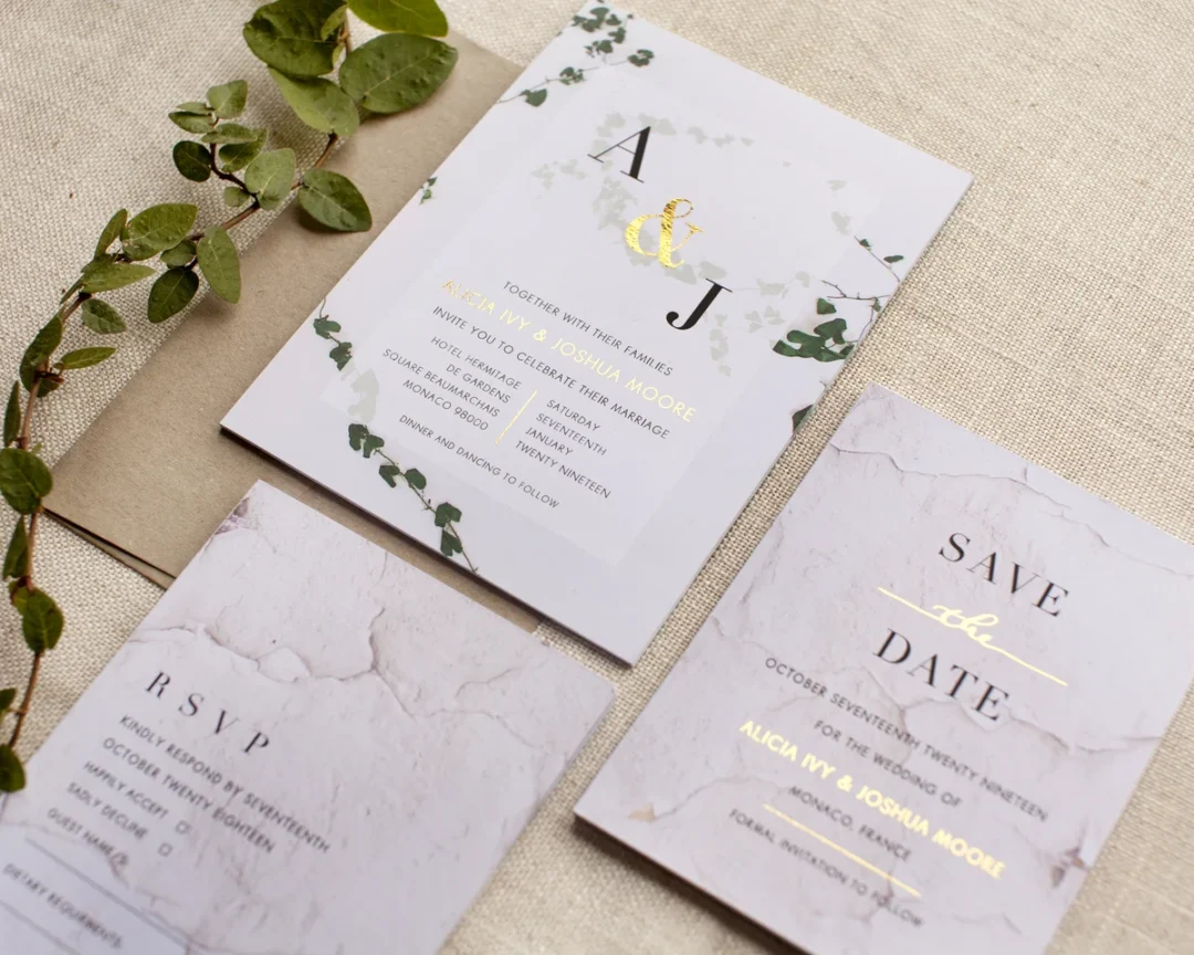 Save the date card styled in a soft natural-light flatlay alongside envelope and floral props