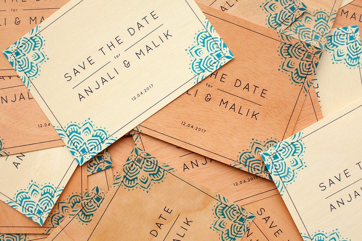 Scattered stack of Paperlust save the date cards ready for addressing and mailing